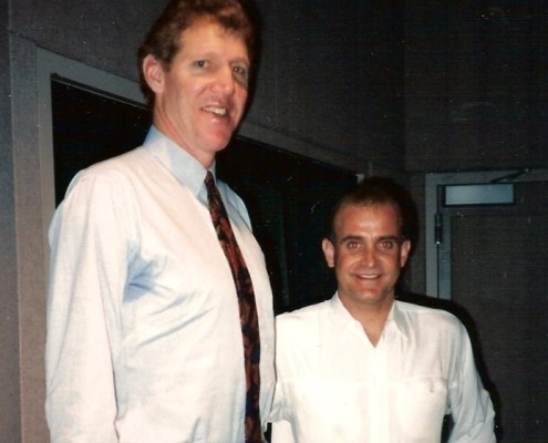 Two men standing next to each other in a room.