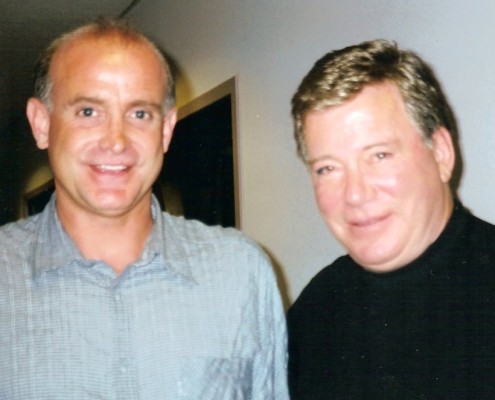 Two men standing next to each other in an office.