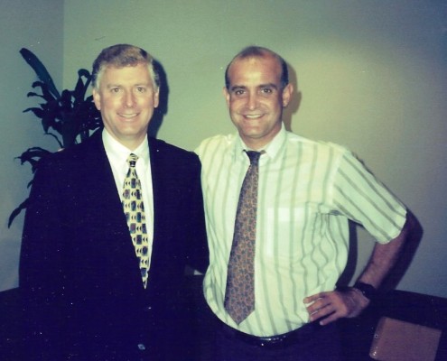 Two men standing next to each other in a room.