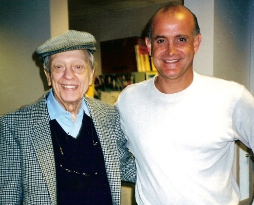 Two men standing next to each other in a room.