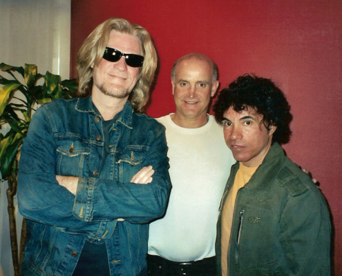 Three men standing next to each other in a room.