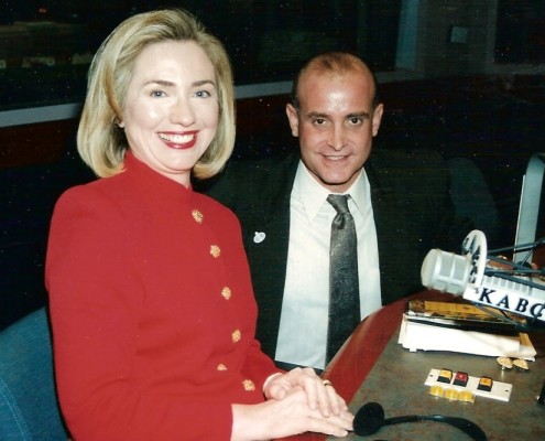 A man and a woman sitting in front of a microphone.