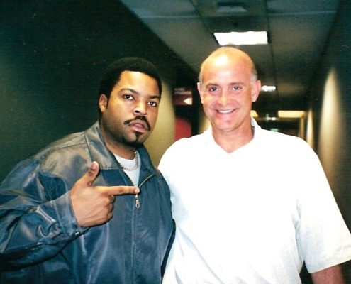 Two men standing next to each other in a hallway.