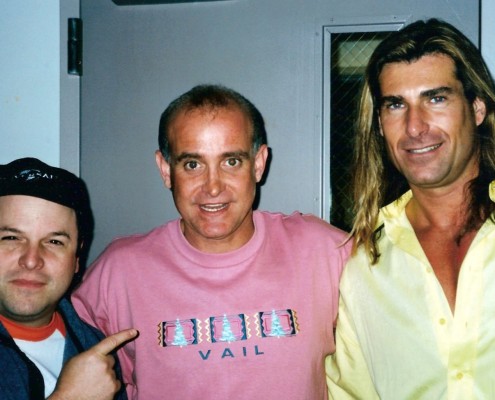 Three men posing for a picture in a room.