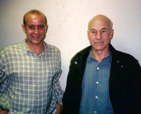 Two men standing next to each other in a room.