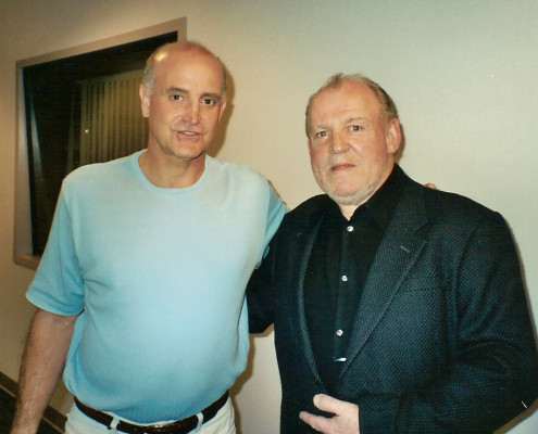 Two men standing next to each other in an office.