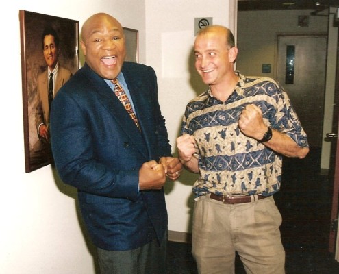 Two men standing next to each other in an office.