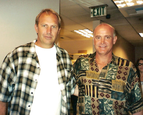 Two men standing next to each other in an office.