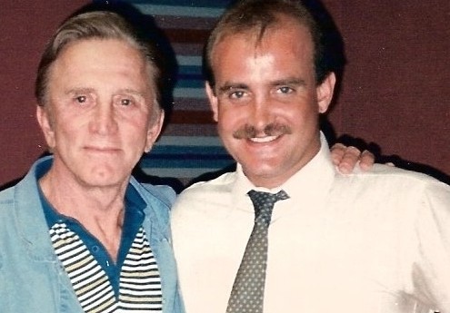 Two men posing for a photo in a recording studio.