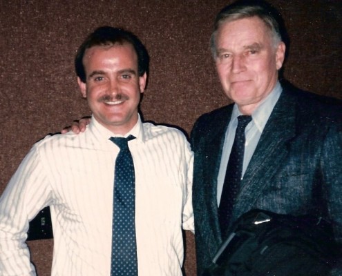 Two men standing next to each other in a room.