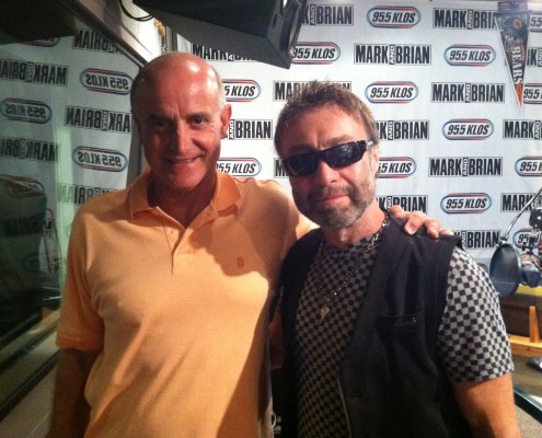 Two men posing for a photo in a radio studio.