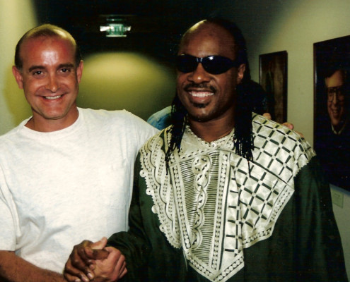 Two men standing next to each other in a hallway.