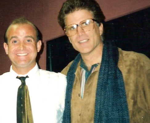 Two men posing for a photo in a recording studio.