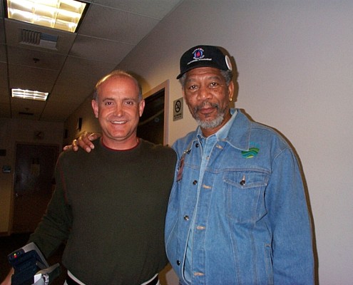 Two men standing next to each other in a hallway.