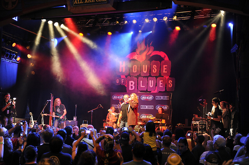 A group of people on stage at a concert.