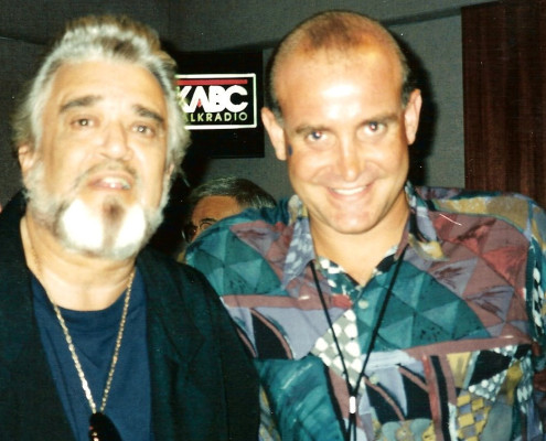 Two men standing next to each other in a recording studio.