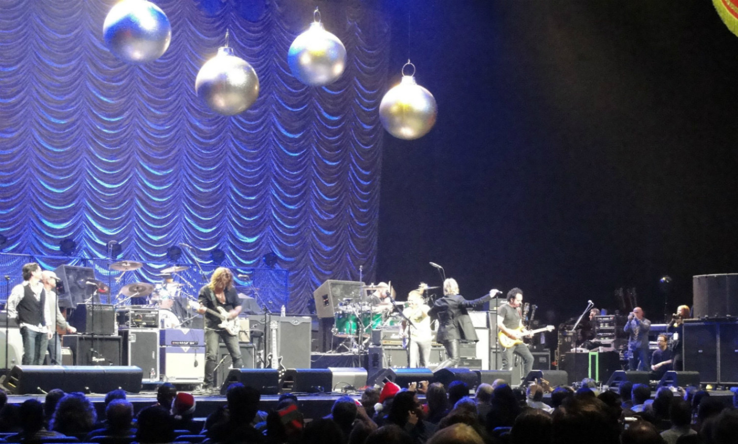 A group of people on stage with christmas ornaments.