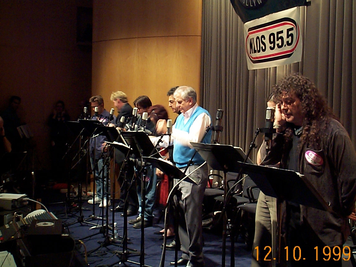 A group of people standing in front of microphones.