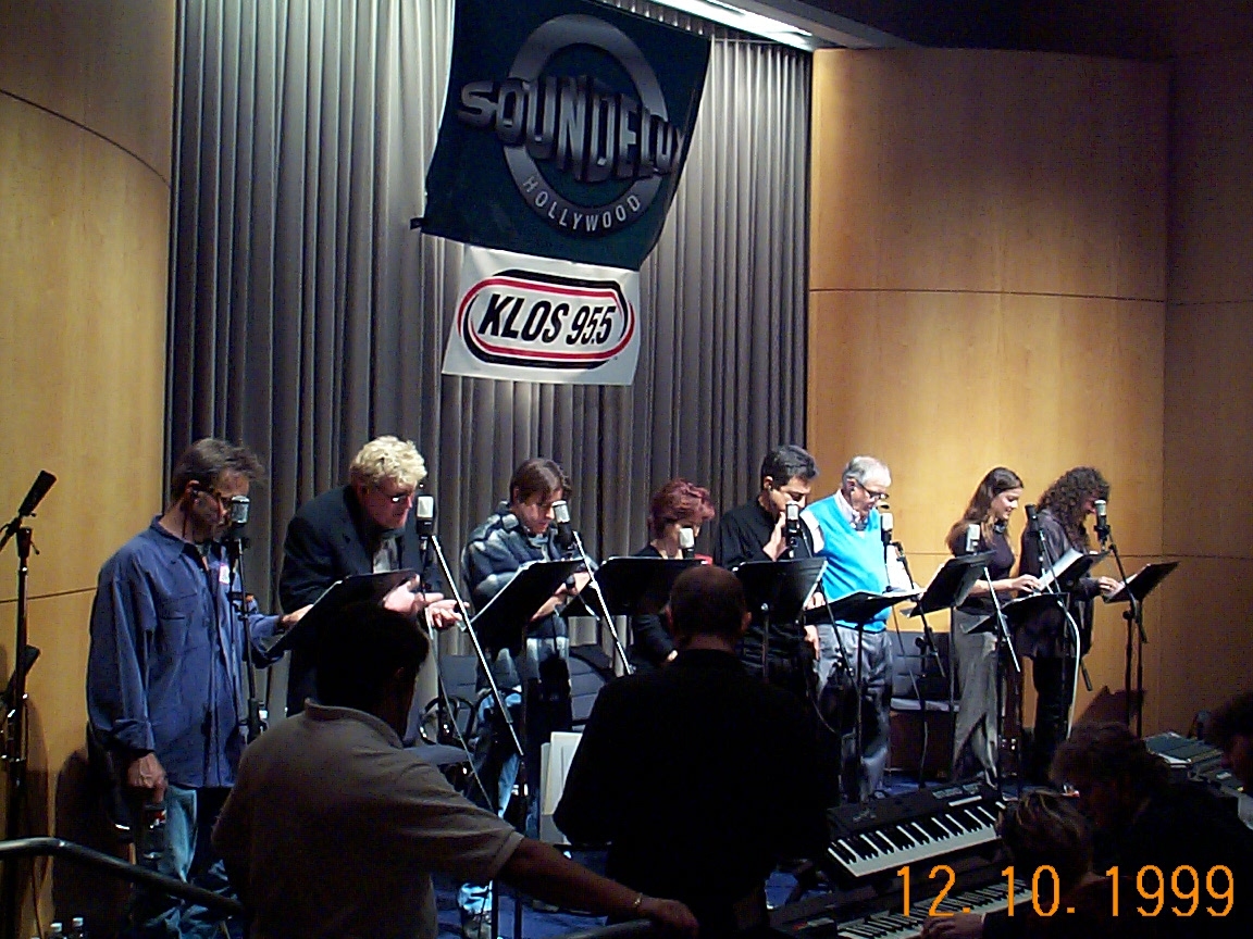 A group of people standing in front of a microphone.