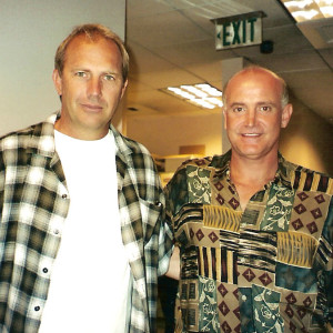 Two men standing next to each other in a room.