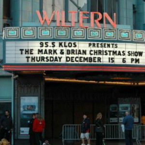 A theater with people standing outside of it.