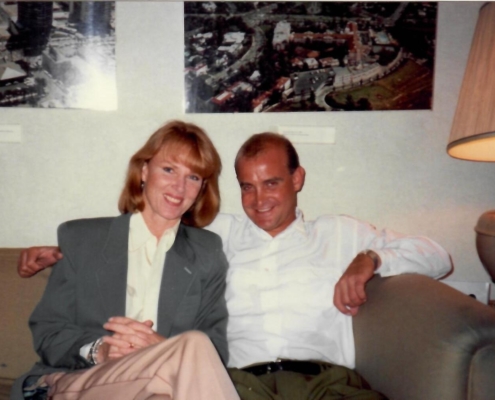 A man and woman sitting on the couch together.