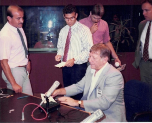 A group of people standing around a table.