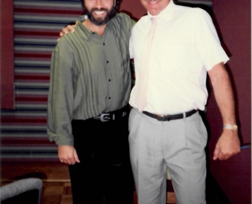 Two men standing next to each other in a room.